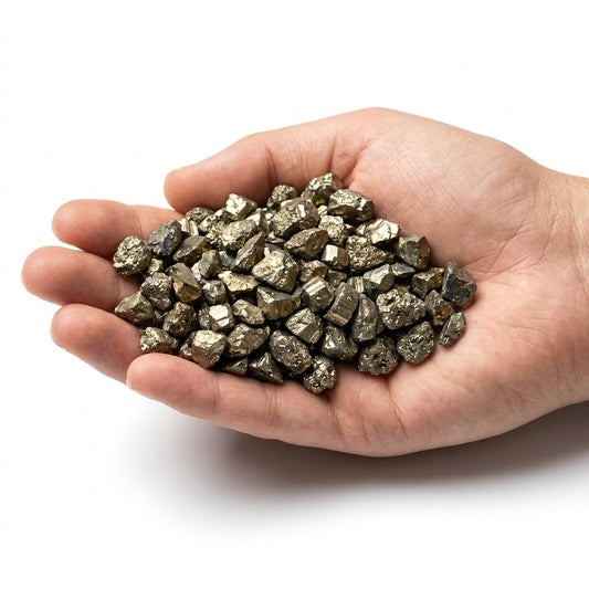 A hand holding a heap of natural raw pyrite chips on a white background