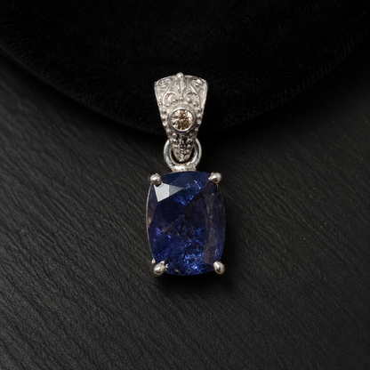 Natural tanzanite and lab-grown diamond pendant in 925 silver, front view on black velvet