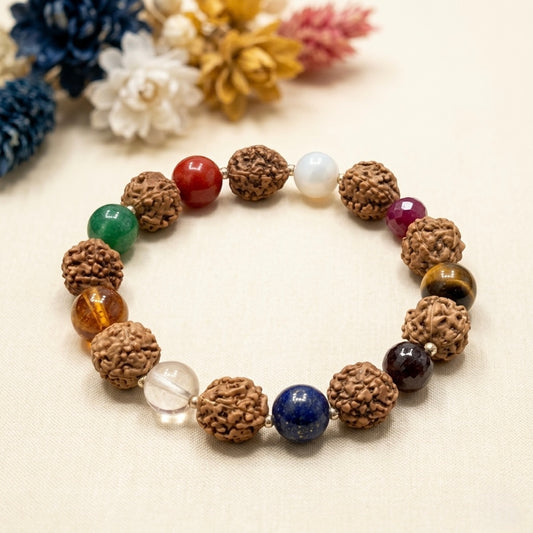 Navratan and rudraksha bead bracelet with colorful gemstones on beige background