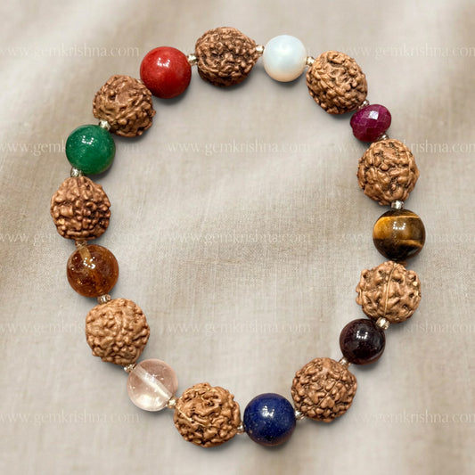 Rudraksha bracelet beads with navratan gemstones close-up on gray fabric background