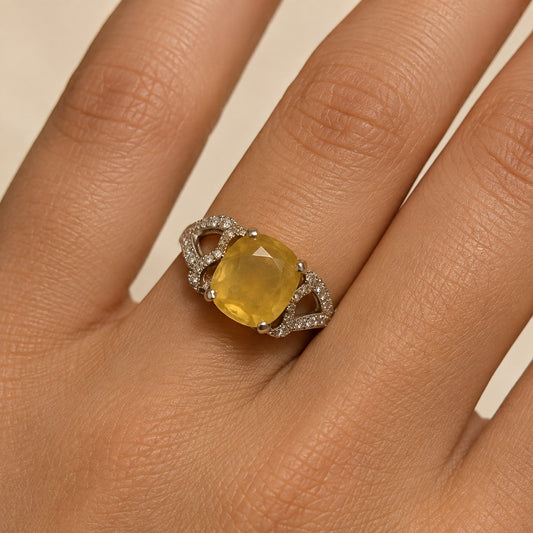 Yellow sapphire pukhraj ring in 925 silver shown on hand with oval cushion gemstone