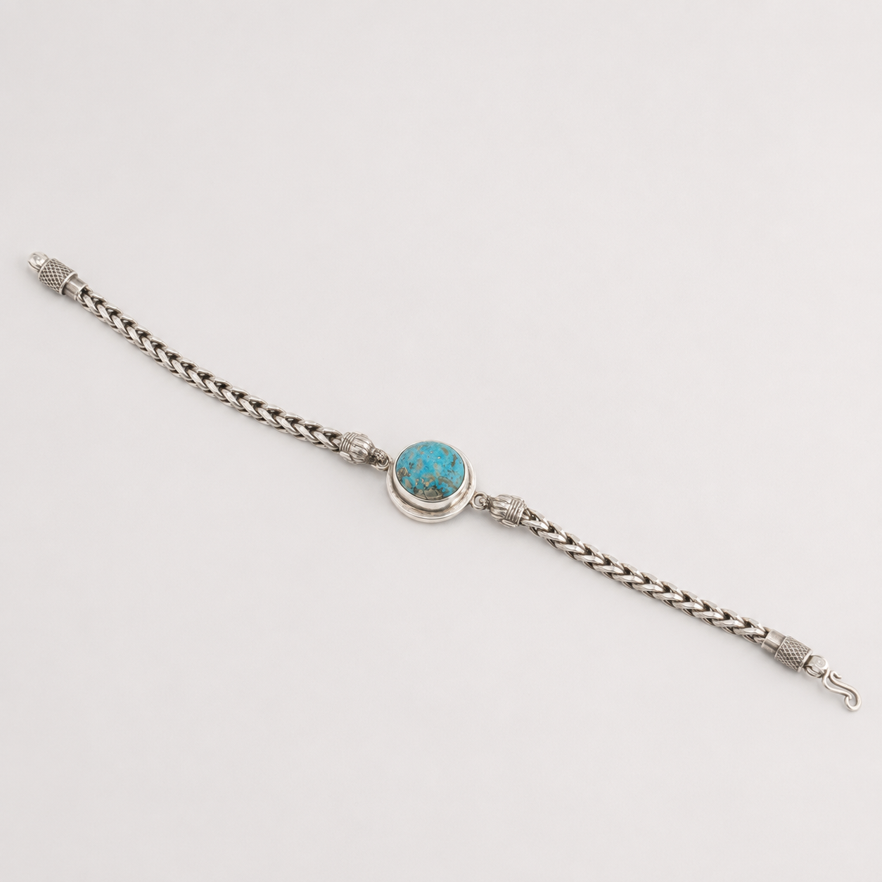 Unisex oval turquoise 925 sterling silver bracelet laid flat with blue oval stone and lobster clasp