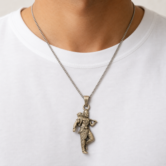Lord Parashurama axe pendant worn on a silver chain against a white shirt
