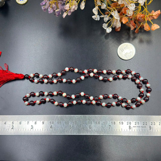 Pearl and garnet jaap mala necklace beads with red tassel, measured with a ruler
