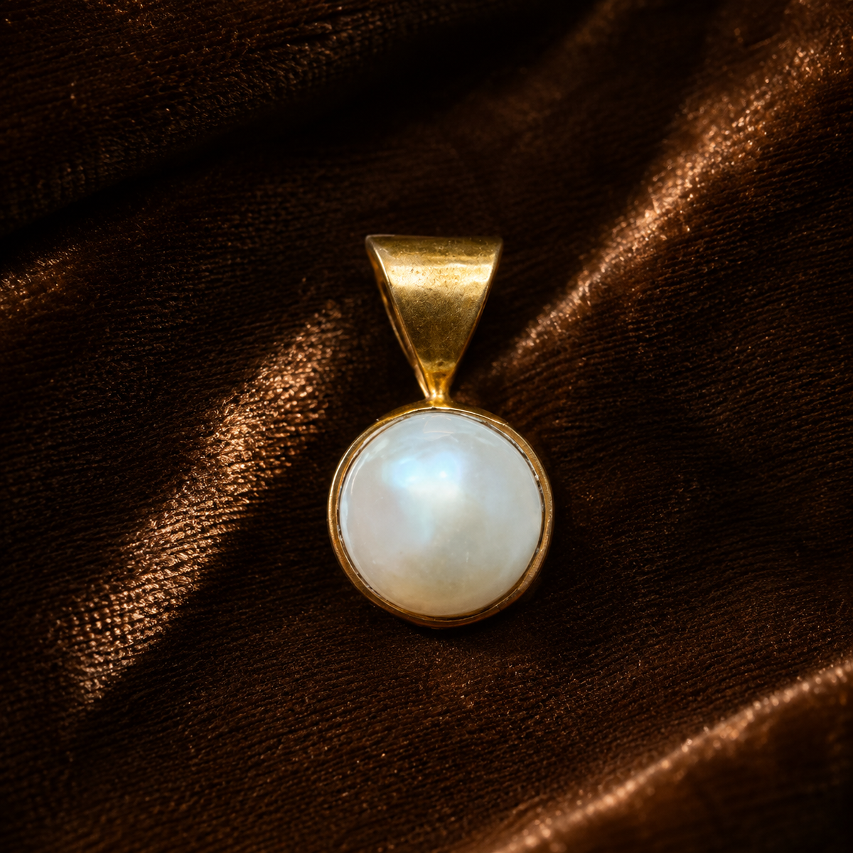 Pearl panchdhatu locket pendant with round mother-of-pearl style center on dark fabric