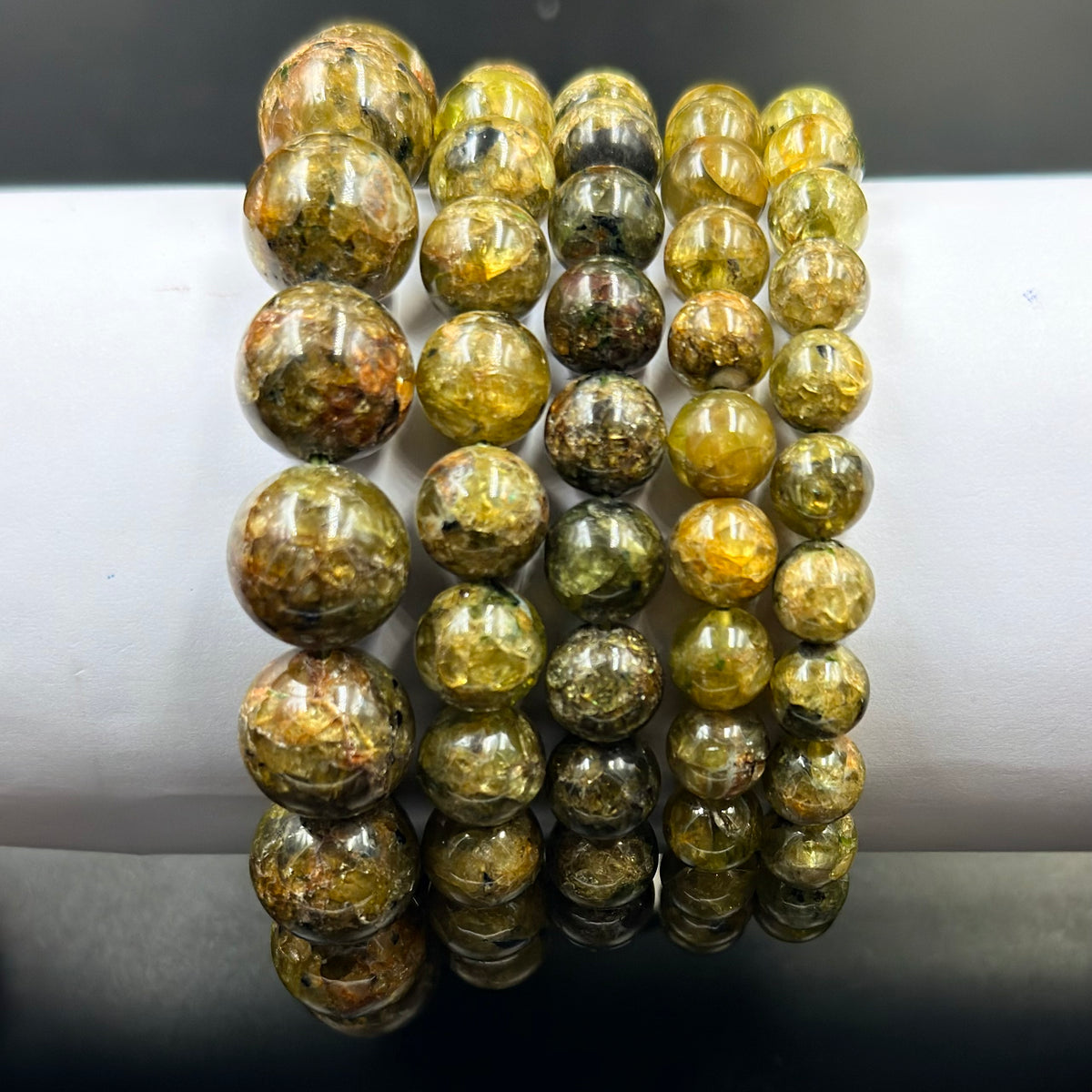 Close-up of peridot AA quality bracelet round green beads with natural texture