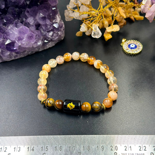 Pisces zodiac bracelet in citrine and tiger eye beads with black zodiac charm on gray background