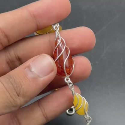 925 Sterling Silver Amber Bracelet (Positivity & Confidence) Each piece is individually secured in an artistic sterling-silver wire setting and joined to create an elegant link bracelet with a lobster clasp, extension chain and Amber drop detail.