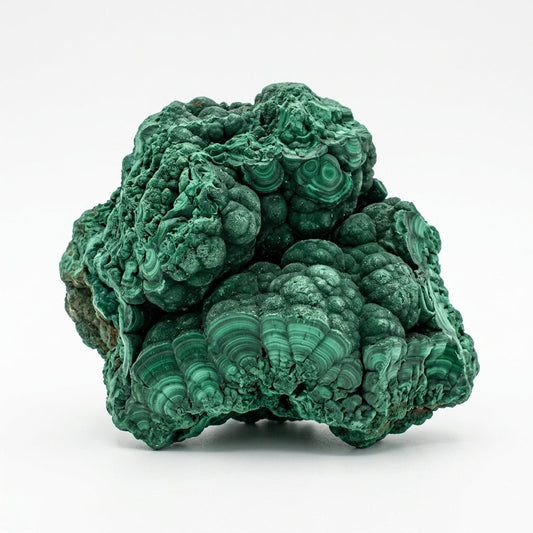 Raw natural malachite crystal cluster with layered green bands on white background