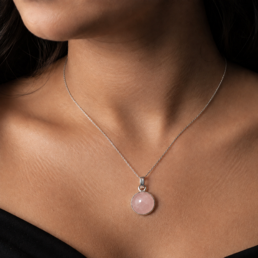 Rose quartz cabochon pendant in German silver worn on necklace chain against skin