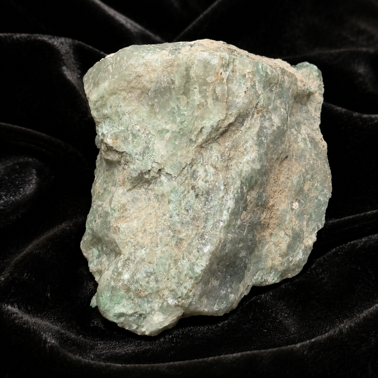 Raw rough Amazonite crystal stone in pale aqua and white on black velvet