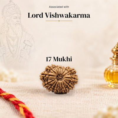 17 Mukhi Nepal Rudraksha bead on beige linen with moli thread and oil bottle, faded sketch of Lord Vishwakarma, associated with Lord Vishwakarma.