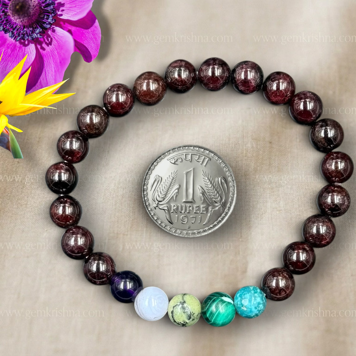 Sagittarius bracelet with dark round beads and colorful stone beads, laid on fabric