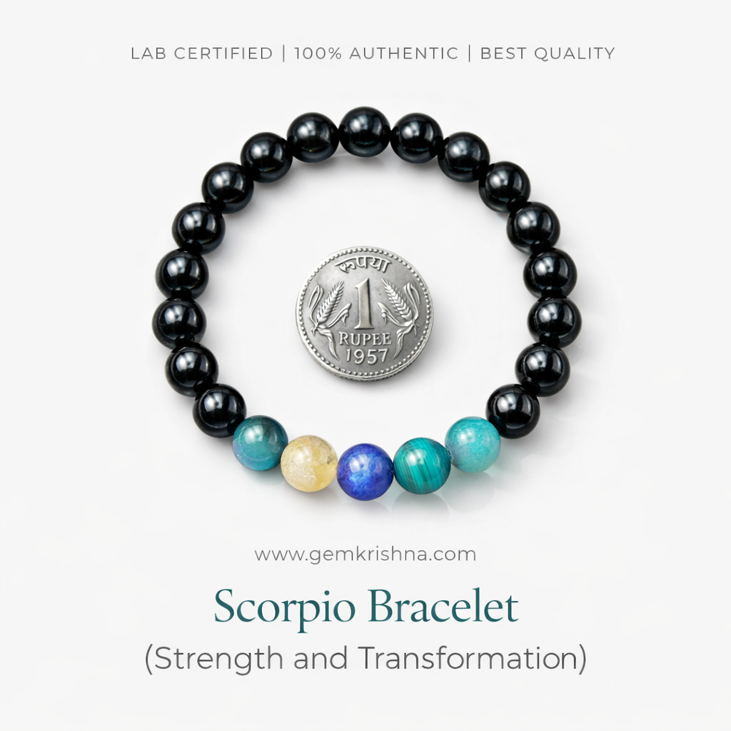 Scorpio bracelet with black beads and colorful gemstone beads, laid flat with a coin for scale