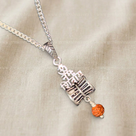 925 silver Shivling and Trishul pendant with rudraksha bead on a chain on beige background