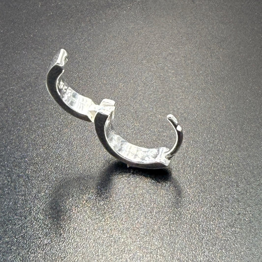 Silver Bali hoop earrings with hinged lock, angled close-up showing the hinge and outer curve