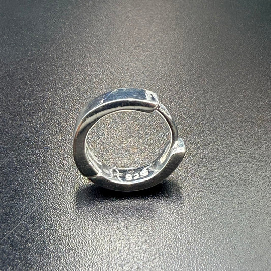 Silver Bali hoop earrings with hinged lock, close-up of the clasp and inside markings
