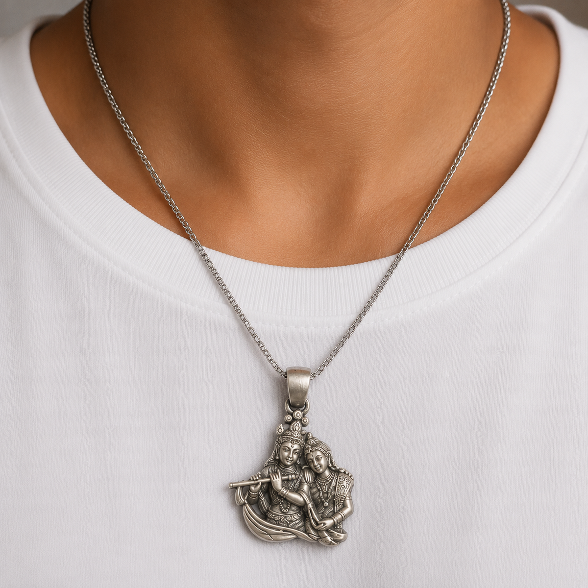 925 silver Radha Krishna flute pendant worn on a silver chain against white fabric