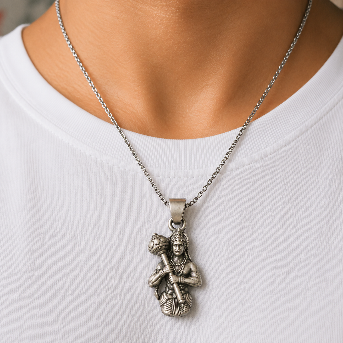 925 silver Lord Hanuman gada pendant worn on a chain necklace against white fabric background
