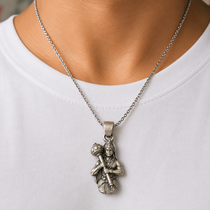 925 silver Lord Hanuman gada pendant worn on a chain necklace against white fabric background