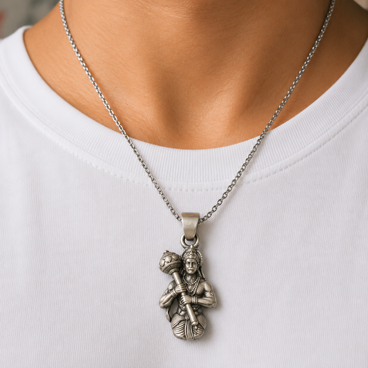 925 silver Lord Hanuman gada pendant worn on a chain necklace against white fabric background
