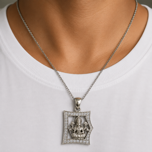 Silver Maa Lakshmi pendant with clear stone frame on chain worn on white shirt
