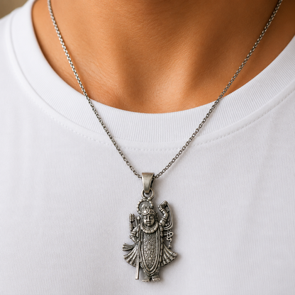 Lord Shrinathji Govardhan Krishna 925 silver pendant worn on a chain against white shirt