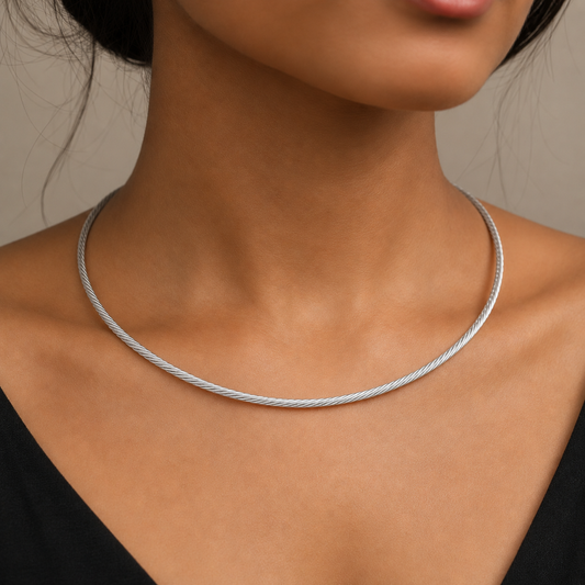 Silver Italian-style twisted hasli necklace worn close-up on the neck with minimal collar chain