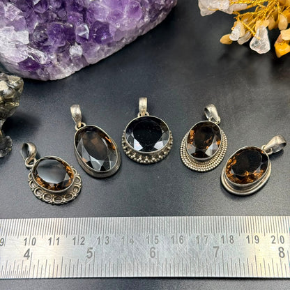Oval smoky quartz 925 silver locket pendant setting on display with ruler background