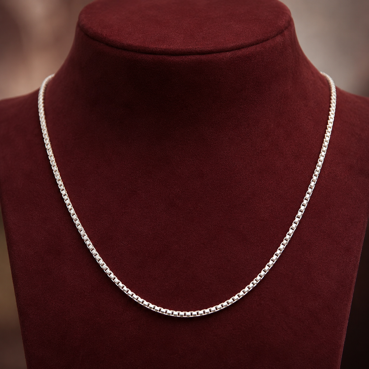 Sterling silver box chain necklace on burgundy velvet display