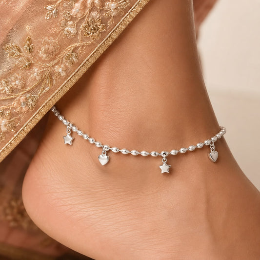 925 sterling silver beaded star and heart charm anklet on a woman’s ankle