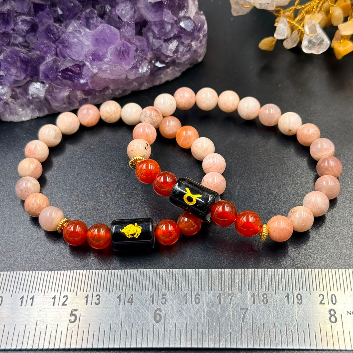 Taurus zodiac bracelet with sunstone and carnelian beads, black square center with gold bull symbol