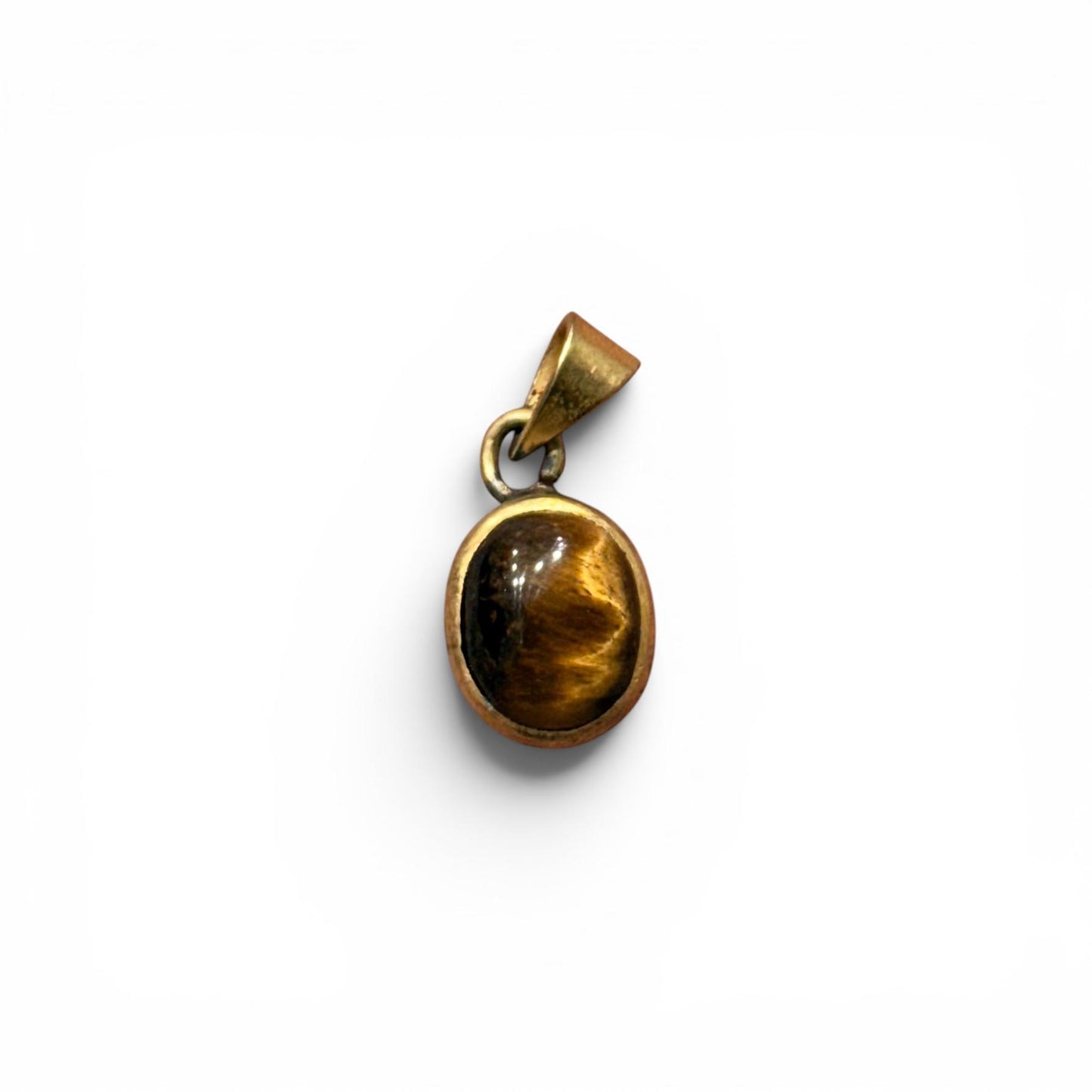 Tiger eye panchdhatu locket pendant with oval stone and gold-toned protective frame