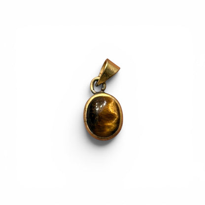 Tiger eye panchdhatu locket pendant with oval stone and gold-toned protective frame