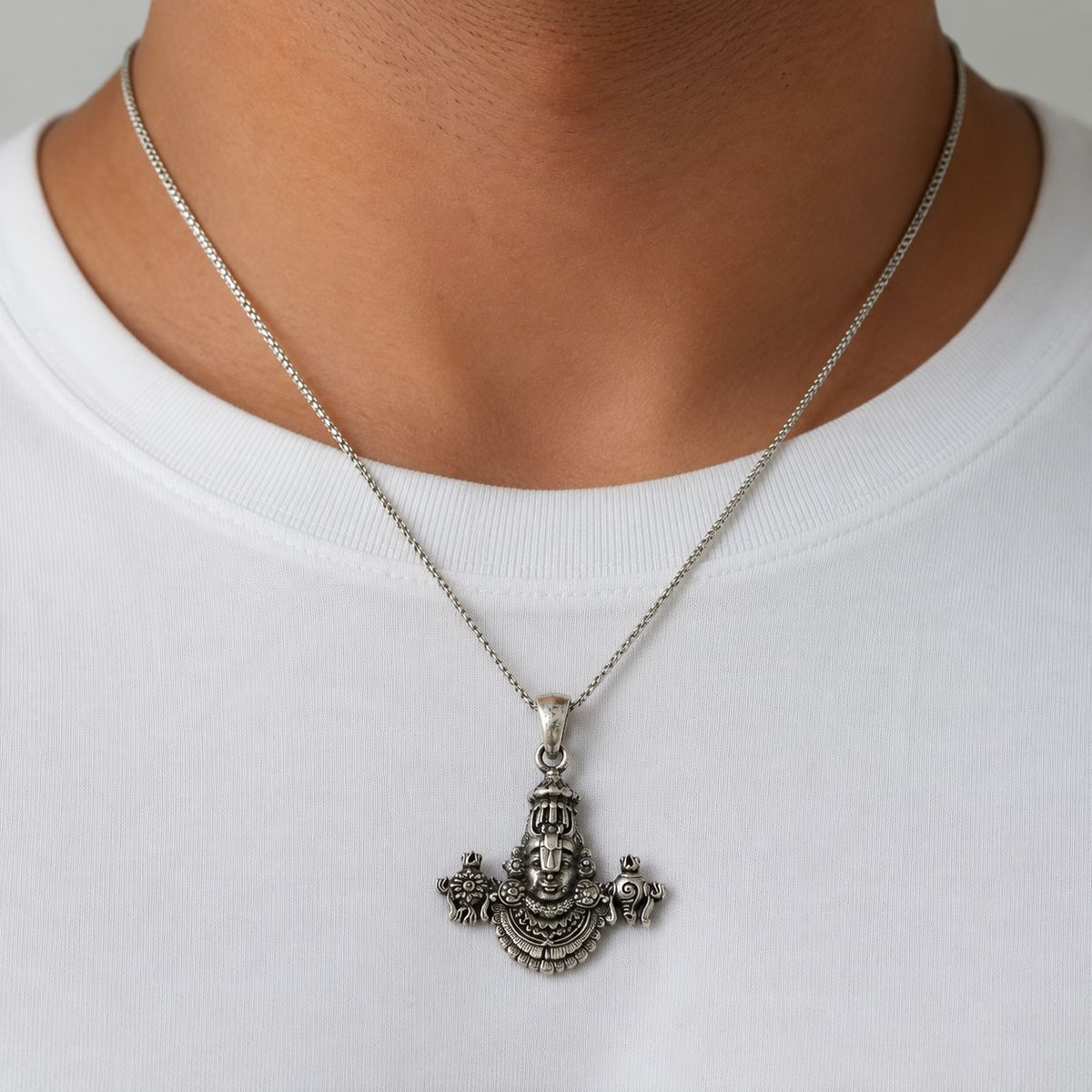 Silver Tirupati Balaji Venkateswara pendant necklace worn on a white shirt