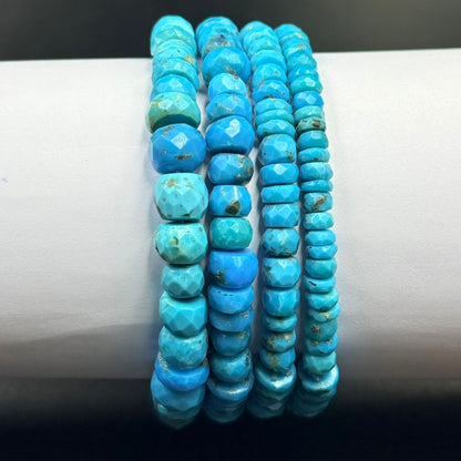 Close-up of turquoise flat rondelle beads with faceted texture and small natural marks
