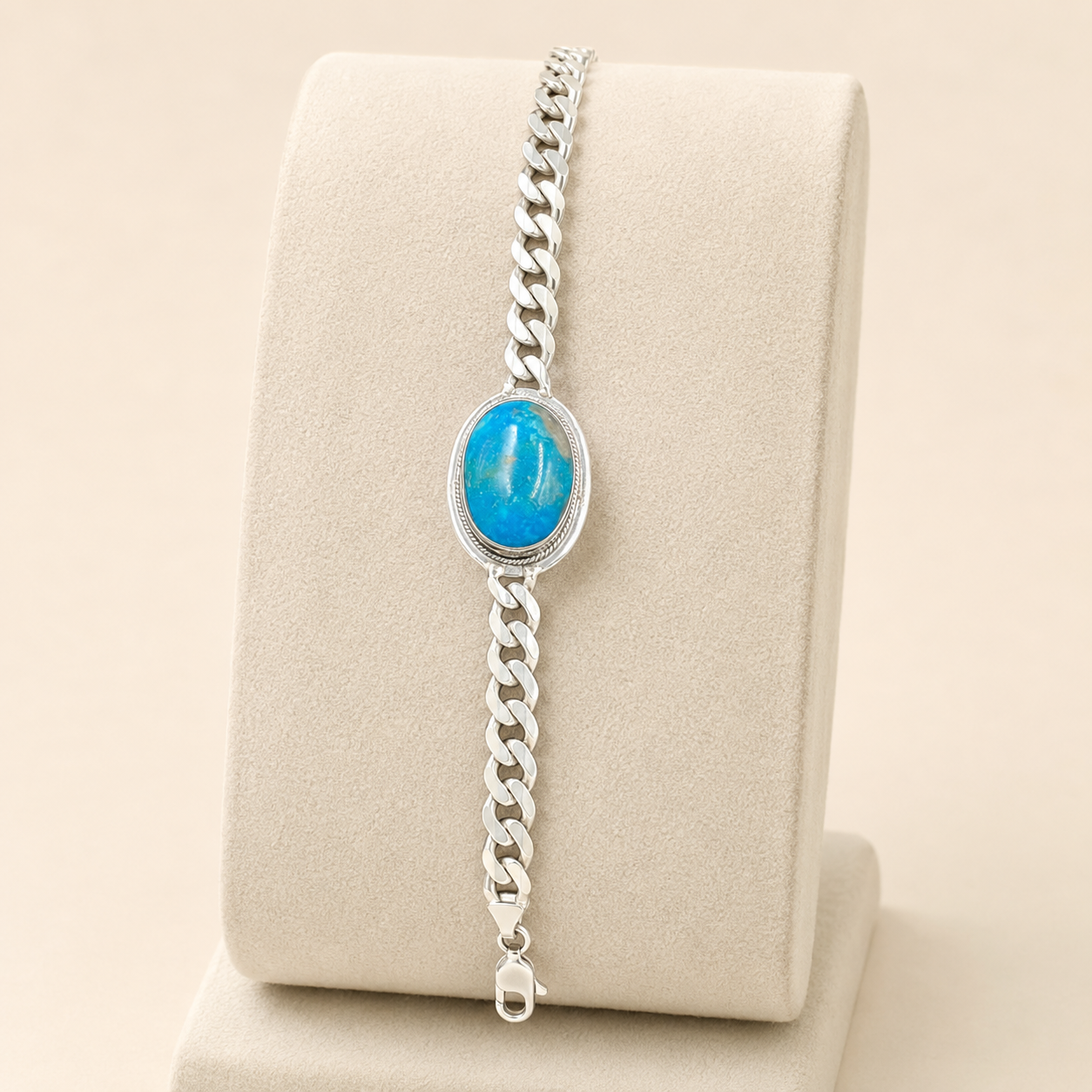 Turquoise oval stone centerpiece on 925 sterling silver Cuban link bracelet on display stand
