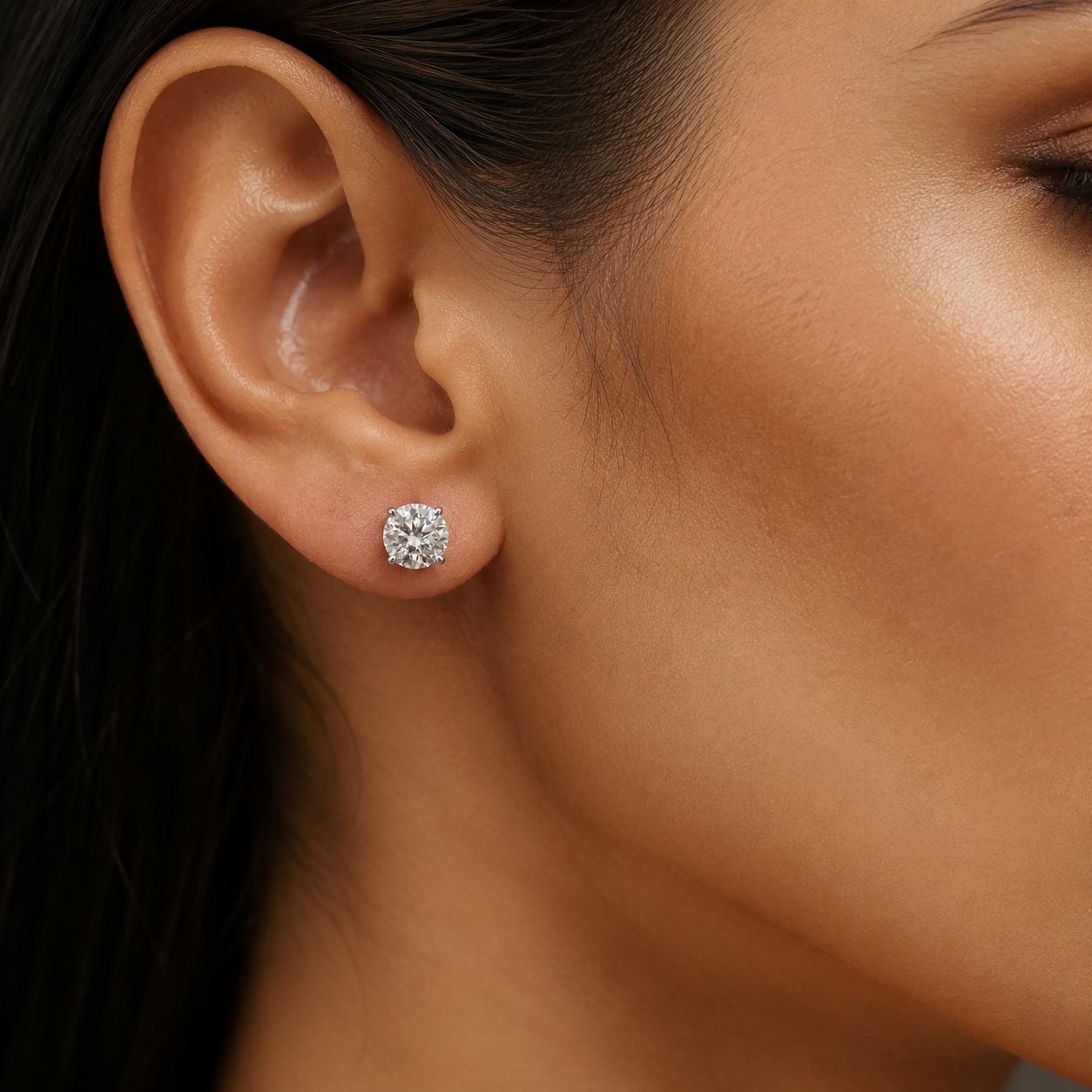 2.97 carat moissanite stud earrings in 925 silver worn on ear with round solitaire sparkle