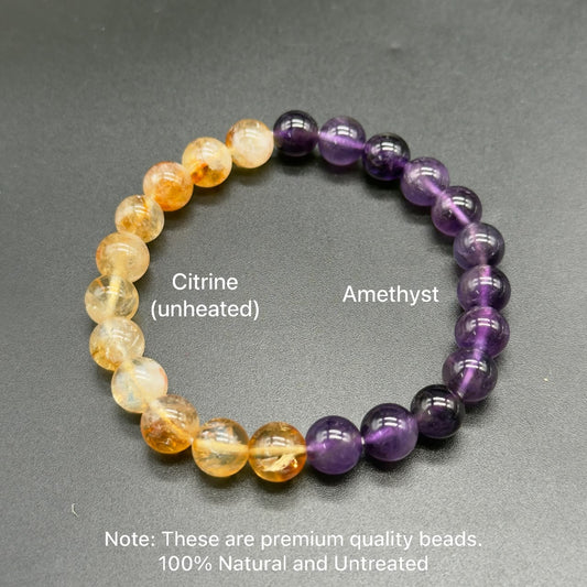Unheated citrine and untreated amethyst round bead bracelet on dark textured background