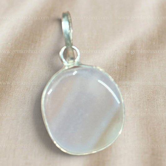 Close-up of a white Sulemani agate locket pendant with oval stone and silver-toned loop
